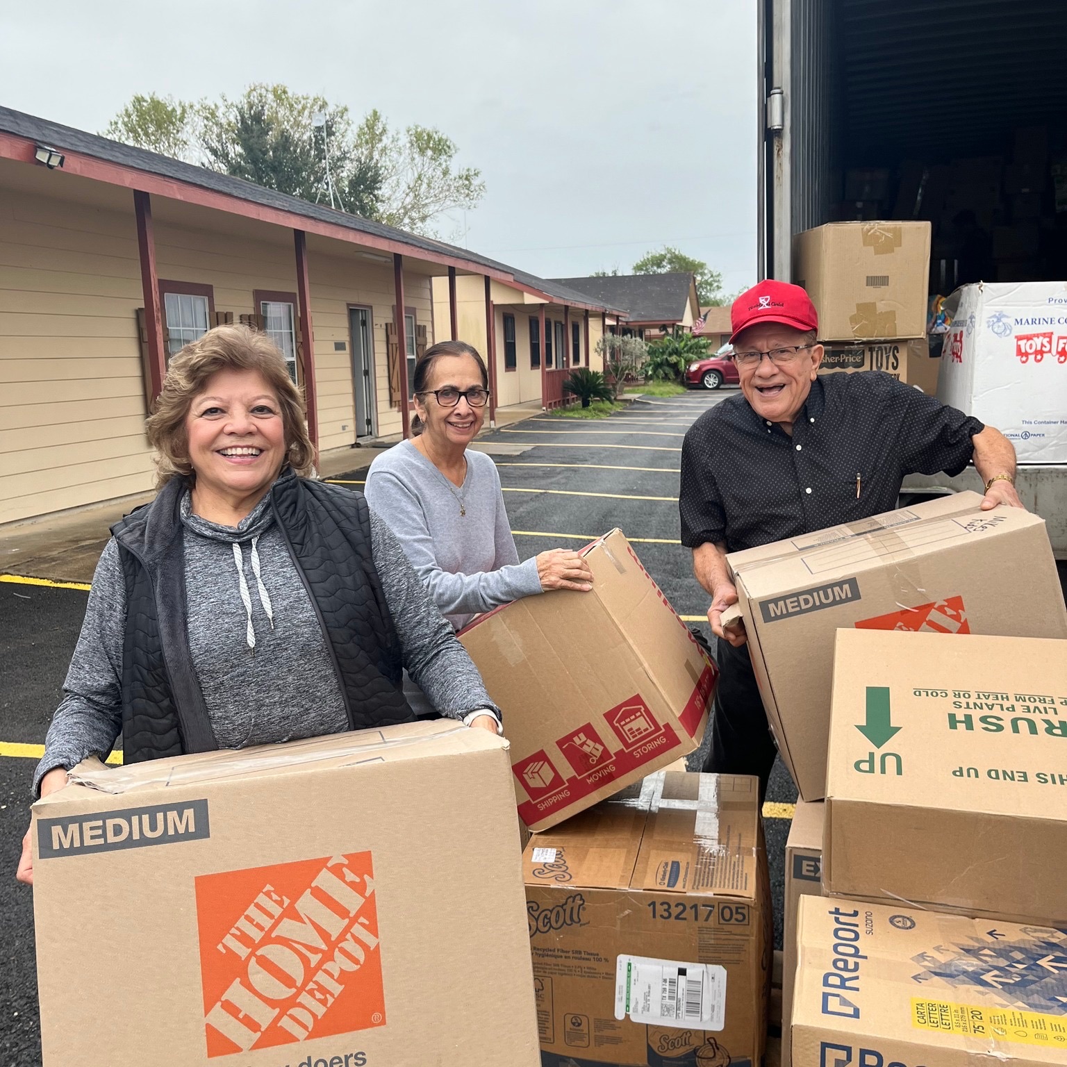 Volunteers carrying donated boxes outdoors